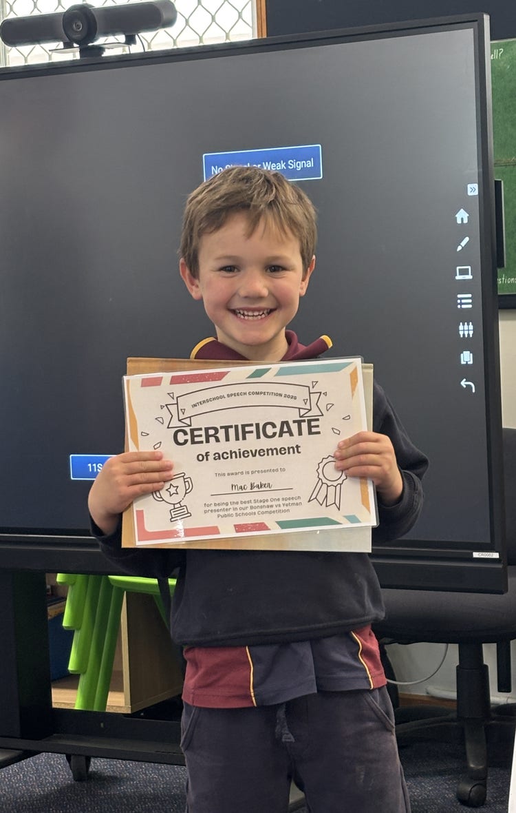 An image of a smiling student showing his certificate a achievement for public speaking